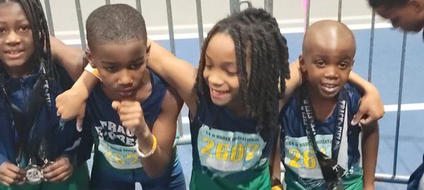 Track Express teammates smiling together with their medals