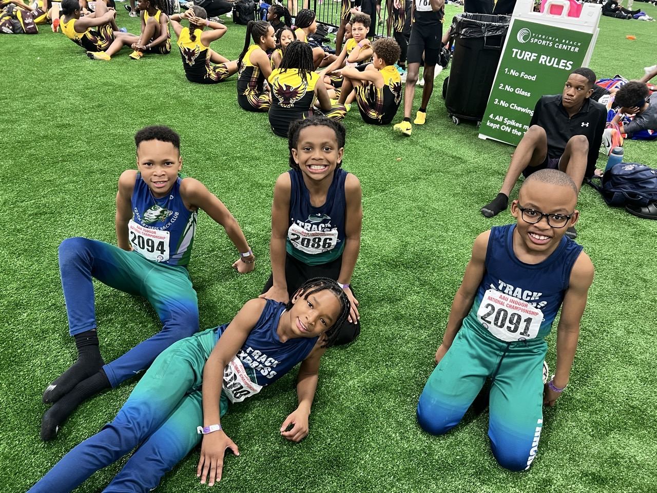 Track Express athletes relaxing on the infield turf between events